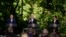 South Korea's President Yoon Suk Yeol, left, and Japan's Prime Minister Fumio Kishida, right, listen as President Joe Biden speaks during a news conference, Aug. 18, 2023, at Camp David, the presidential retreat, near Thurmont, Md.