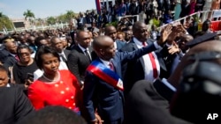 Foto Achiv: Prezidan Jovenel Moise mache ak madanm ni Martine pou al nan Pale Nasyonal la apre envestiti li nan Potoprens, 7 Fevriye 2017. 
