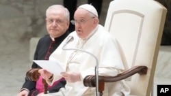 Pope Francis delivers his message as he meets with Vatican employees for the season greetings at the Vatican, Dec. 21, 2023.