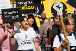Strikers walk a picket line outside Warner Bros., Discovery, and Netflix offices in Manhattan, N.Y., Aug. 18, 2023.