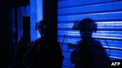 FILE - This handout picture released by the Israeli army on Nov. 15, 2023, shows soldiers during a military operation around at Al-Shifa hospital in Gaza City.