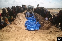 Palestinians attend a mass funeral of people killed in the Israeli offensive on Khan Younis in Rafah, Gaza Strip, March 7, 2024.