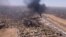 This image grab taken from AFPTV video footage on April 20, 2023, shows an aerial view of black smoke rising above the Khartoum International Airport amid ongoing battles between the forces of two rival generals.