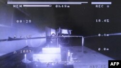 Pendaratan drone selama "investigasi internal kapal penahanan utama" Unit 1 di Pembangkit Listrik Tenaga Nuklir Fukushima Daiichi yang lumpuh di Okuma, Prefektur Fukushima, dalam selebaran bertanggal 28 Februari 2024. (TEPCO/ AFP) 