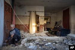 Palestinians look at the destruction after an Israeli strike in Rafah, southern Gaza Strip, Dec. 29, 2023.