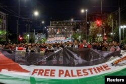 People march towards the Israeli embassy during a pro-Palestinian protest in Athens, Greece, Oct. 18, 2023.