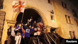 Protesters barricade the entrance of Georgia's Parliament in Tbilisi, Georgia, during a rally to protest a bill on "foreign agents," May 2, 2024.