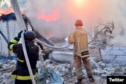 Emergency personnel put out fires caused by Russian shelling in Kherson, Ukraine, in this image tweeted by The State Emergency Service of Ukraine on Aug. 3, 2023.