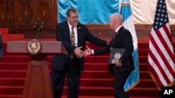 Guatemalan President Bernardo Arevalo, left, shakes hands with U.S. Homeland Security Secretary Alejandro Mayorkas at the end of their joint news conference at the National Palace in Guatemala City, March 21, 2024. 