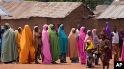 FILE - Parents wait for news about the kidnapped LEA Primary and Secondary School Kuriga students in Kuriga, Kaduna, Nigeria, on March 9, 2024.