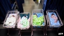 FILE - Newborn babies sleep in cots at a maternity center in Lagos, Nigeria, on Oct. 14, 2022. Screening for sickle cell anemia in newborns is mandatory in Nigeria, but not all hospitals comply with the measure.