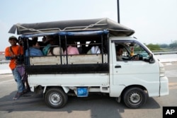 Myanmar residents cross the 1st Thai-Myanmar Friendship Bridge in Myawaddy district in eastern Myanmar, April 12, 2024.