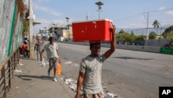 People walk along a street in Port-au-Prince, Haiti, March 13, 2024.
