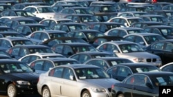 FILE - Imported German-made BMWs are parked at the North East Auto Terminal, Oct. 23, 2008, in Jersey City, New Jersey. BMW and two other automakers have used parts from a Chinese supplier banned in the U.S. for forced labor, congressional investigators said.
