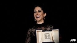 Iranian actress Zar Amir-Ebrahimi poses with her trophy after she won the Best Actress Prize for her part in "Holy Spider" during the closing ceremony of the 75th edition of the Cannes Film Festival in Cannes, France, May 28, 2022. 