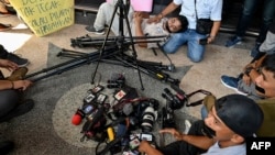 Journalists lay down their equipment as they protest the latest draft revision of the broadcasting law, which they consider a threat to press freedom, in Banda Aceh, Indonesia, on May 27, 2024. 