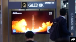 A TV screen shows a report of North Korea's rocket launch with a file image during a news program at the Seoul Railway Station in Seoul, South Korea, Aug. 24, 2023.