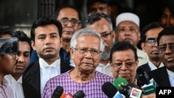 FILE - Nobel peace laureate Muhammad Yunus, center, speaks to the media in Dhaka, May 23, 2024. Yunus has been chosen to head Bangladesh's interim government after the nation's prime minister resigned and fled abroad in the face of a broad uprising against her rule.