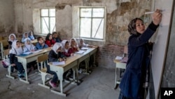 FILE - A teacher leads a class of girls on the first day of the school year, in Kabul, Afghanistan, March 25, 2023. Taliban bans in the country prohibit access to education for girls age 12 and older. 