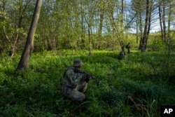 A Ukrainian Border Guard soldier participates in a military exercise in central Ukraine, May 2, 2023.