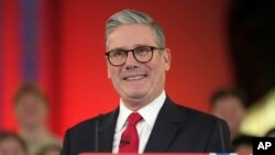 Labour Party leader Keir Starmer smiles as he speaks to his supporters at the Tate Modern in London, July 5, 2024. 