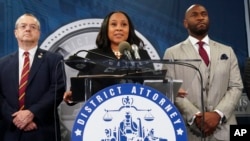 Fulton County District Attorney Fani Willis, center, speaks at the Fulton County Government Center during a news conference, in Atlanta, Georgia, Aug. 14, 2023.