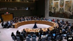 Representatives of member countries take votes during a Security Council meeting at United Nations headquarters, April 18, 2024. 