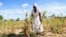 A villager shows maize crops wilting in a field, in Mumijo, Buhera district, east of the capital Harare, Zimbabwe, March 16, 2024. 