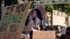Students hold up a photo of University of Southern California 2024 valedictorian Asna Tabassum in protest to her canceled commencement speech on the campus of University of Southern California, in Los Angeles, April 18, 2024. 