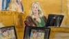 Stormy Daniels testifies on the witness stand as a promotional image for one of her shows featuring an image of former U.S. President Donald Trump is displayed on monitors in Manhattan criminal court in New York, May 9, 2024.