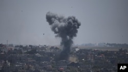 Smoke rises from an explosion caused by an Israeli airstrike in the Gaza Strip, May 13, 2023.