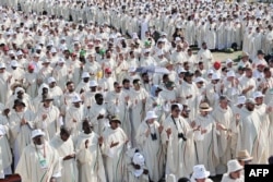Priests pray as they attend the closing mass of the World Youth Days (WYD) in Tejo Park, Lisbon, Aug. 6, 2023.