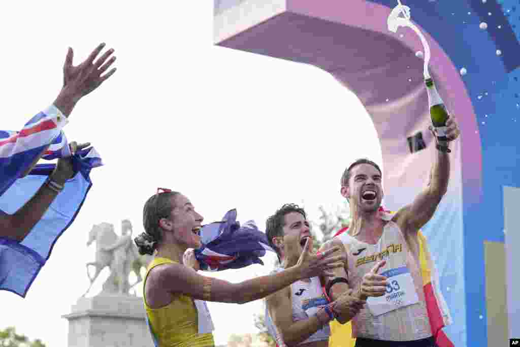 (From left) Australia's Rhydian Cowley, Australia's Jemima Montag, Spain's Maria Perez and Spain's Alvaro Martin celebrate after crossing the finish line at the end of the marathon race walk relay mixed at the 2024 Summer Olympics, in Paris, France.