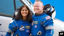 FILE - NASA astronauts Suni Williams and Butch Wilmore stand together for a photo en route to the launch pad at Space Launch Complex 41 June 5, 2024, in Cape Canaveral, Fla.