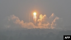 A Long March-5 rocket, carrying the Chang'e-6 mission lunar probe, lifts off as it rains at the Wenchang Space Launch Center in southern China, May 3, 2024. Pakistan's first lunar satellite was aboard the rocket.