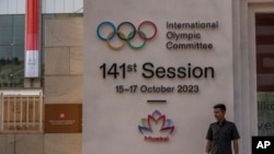 A security guard stands at the entrance of a venue ahead of the 141st International Olympic Committee session in Mumbai, Oct. 12, 2023.