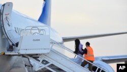Venezuelan migrants board a plane in Harlingen, Texas, Oct. 18, 2023. One hundred thirty-five migrants were deported from the U.S. to Caracas, Venezuela. 