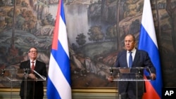 Russian Foreign Minister Sergey Lavrov, right, and his Cuban counterpart Bruno Eduardo Rodríguez Parrilla attend a joint news conference following their talks in Moscow, June 12, 2024. (Natalia Kolesnikova/Pool Photo via AP)