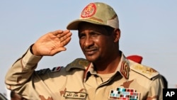 FILE - Gen. Mohammed Hamdan Dagalo, then deputy head of the military council, salutes during a rally, in Galawee, northern Sudan, June 15, 2019.