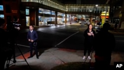 Television reporters broadcast in front of the University of Cincinnati Medical Center, in Cincinnati, Ohio, Jan. 2, 2023.
