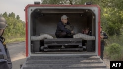 Oleksandr, an evacuee from the front-line village of Lyptsi arrives in an armored vehicle at a checkpoint, outside Kharkiv, on May 13, 2024.