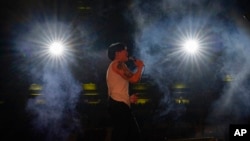 FILE - Chinese rapper Shixin Wenyue performs at a concert in Chengdu in southwestern China's Sichuan province, March 16, 2024. 