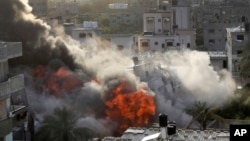 Smoke and fire rise from an explosion caused by an Israeli airstrike targeting a building in Gaza, May 13, 2023. 