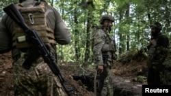 National Guard of Ukraine artillerymen wait to fire towards Russian troops, amid Russia's attack on Ukraine, near the village of Lyptsi in Kharkiv region, Ukraine June 17, 2024.