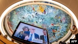 UN High Commissioner for Human Rights Volker Türk is seen on a TV monitor as the ceiling of the Human Rights and Alliance of Civilizations Room is seen in the background at the opening of the 53rd UN Human Rights Council in Geneva, June 19, 2023.