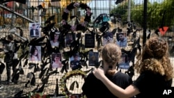 Members of the Druze minority visit a makeshift memorial for 12 children and teens killed in a rocket strike on a soccer field, in the village of Majdal Shams, in the Israeli-annexed Golan Heights, July 29, 2024.