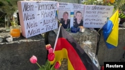 Flowers and candles are placed at the scene, as residents mourn the death of two Ukrainian soldiers in the small southern town of Murnau, Germany, April 29, 2024.
