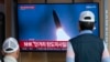 A TV screen shows a file image of North Korea's missile launch during a news program at the Seoul Railway Station in Seoul, South Korea, May 17, 2024. 