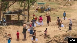 Internally displaced people from Myanmar take aid supplies from Thailand across the border in Mae Sot, Thailand, April 24, 2024. (Tommy Walker/VOA)