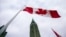 FILE - A Canadian flag flies in front of the peace tower on Parliament Hill in Ottawa, Canada, on Dec. 4, 2015.